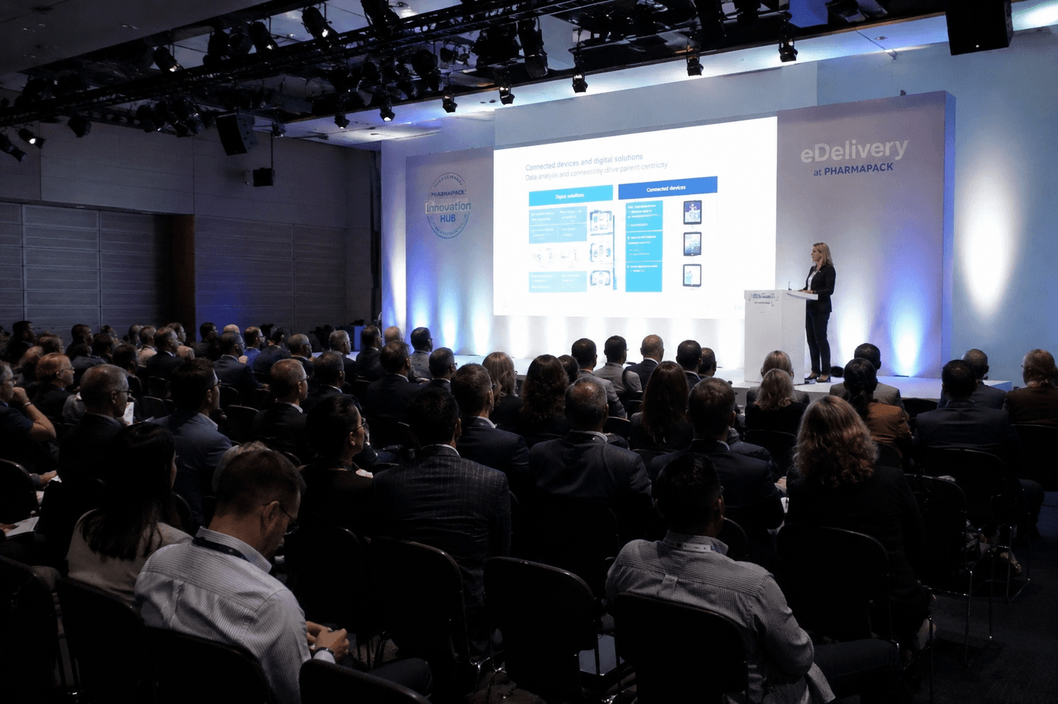 Pharma congress stage with a seated audience